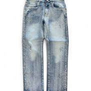 Light blue denim jeans with a faded wash and scattered rhinestone embellishments on the front, photographed flat against a white background.