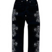 Black denim jeans with intricate silver rhinestone embroidery in a floral pattern on the outer thighs, shown flat against a white background.