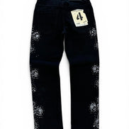 Black denim jeans with white rhinestone embellishments on the outer thighs, shown from the back with a paper tag attached.