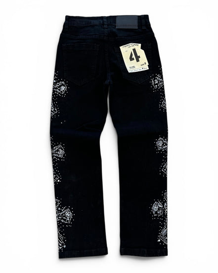 Black denim jeans with white rhinestone embellishments on the outer thighs, shown from the back with a paper tag attached.