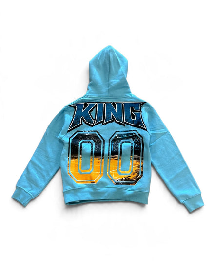 A light blue kids' hooded sweatshirt shown from the back, featuring a large graphic print with the word 'KING' in dark blue letters and the number '00' in yellow, black, and blue.