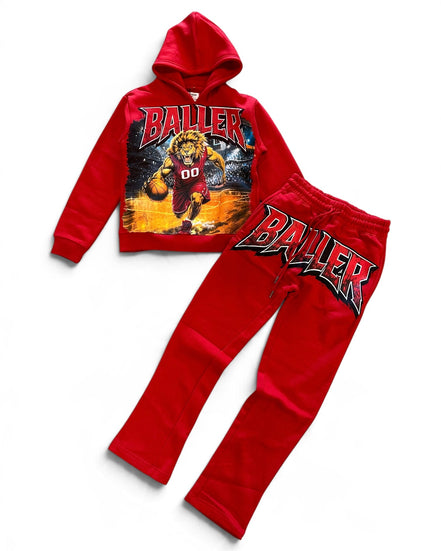 A two-piece kids' sweatshirt and jogger set in bright red, featuring a graphic hoodie with a basketball player print and the word 'BALLER' on the front, paired with matching joggers that have a large 'BALLER' graphic on the thigh.
