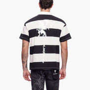 Person wearing a black and white striped t-shirt with visible branding on a white background