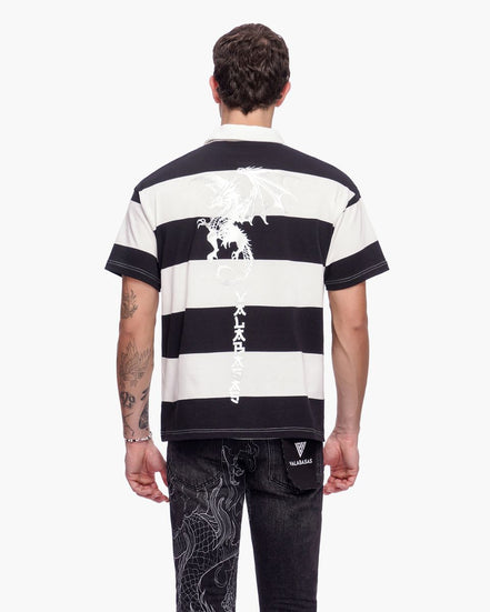 Person wearing a black and white striped t-shirt with visible branding on a white background