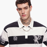 Man wearing a black and white striped polo shirt with dragon design on a white background
