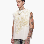 Man wearing a sleeveless embroidered top with intricate designs on a white background