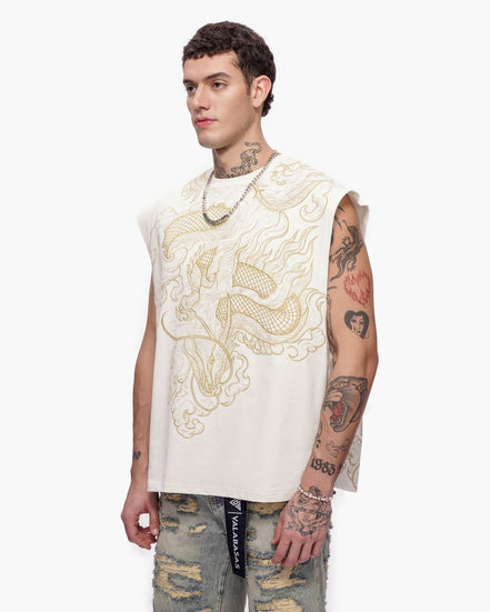 Man wearing a sleeveless embroidered top with intricate designs on a white background