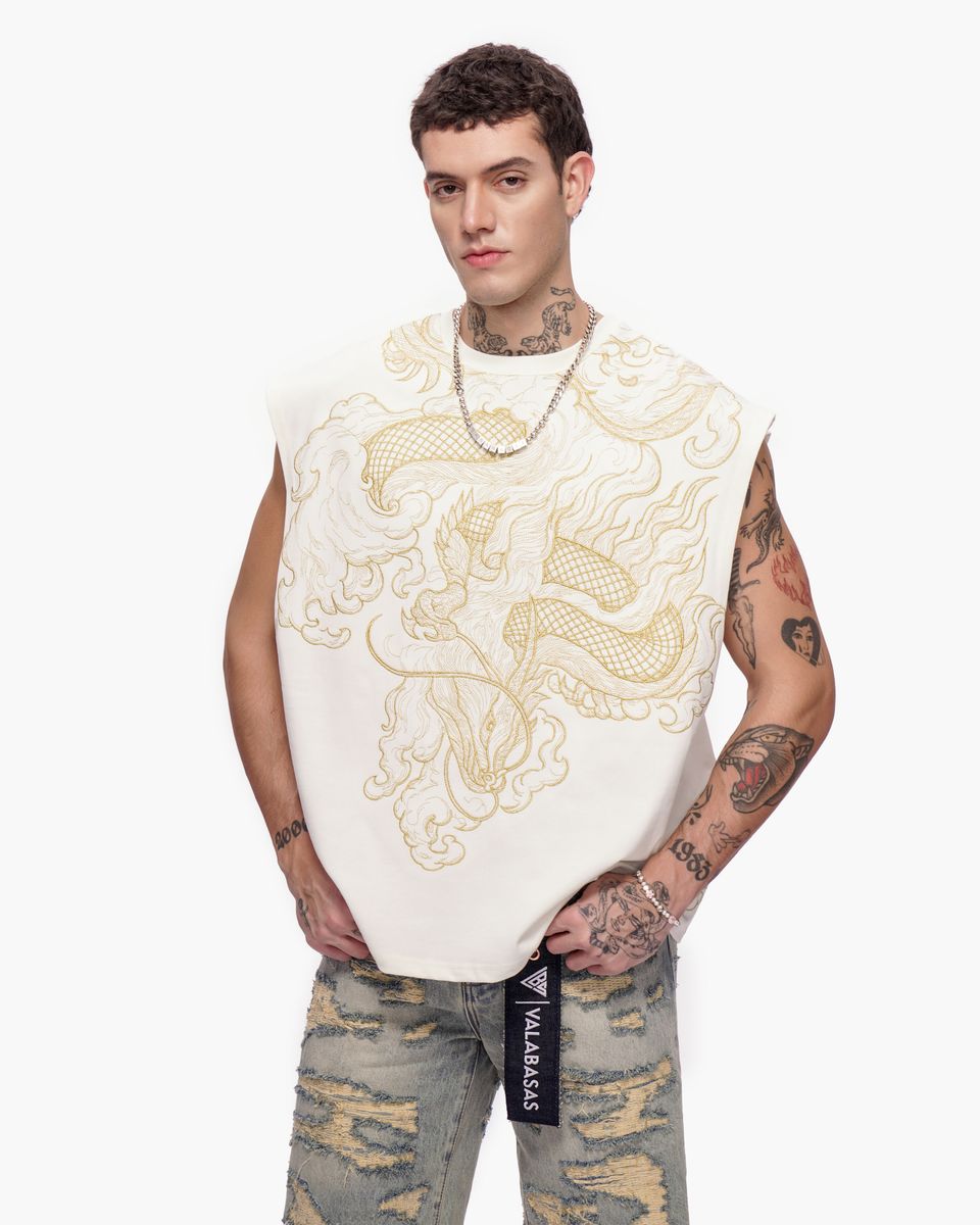 Man wearing a sleeveless embroidered top with a white background