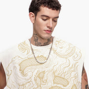 Man wearing a white sleeveless shirt with gold dragon design and a chain necklace on a white background