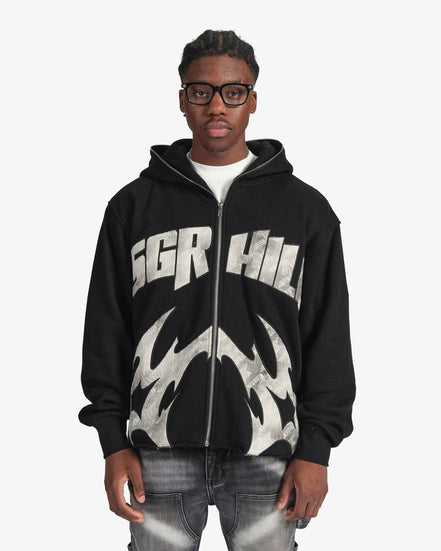 Person wearing a black hoodie with 'SGR HIL' branding on a white background
