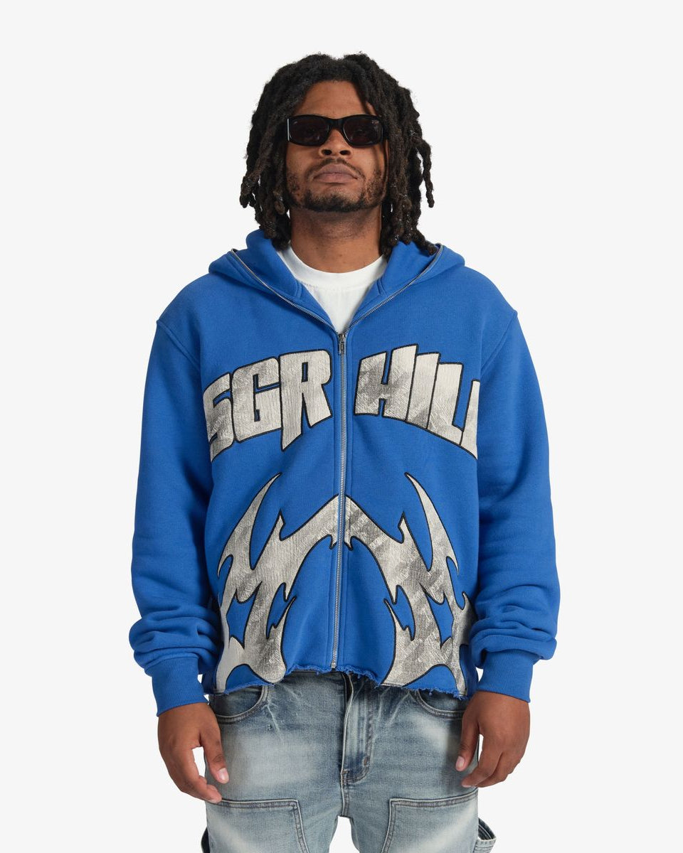 Person wearing a blue hoodie with 'SGR Hill' branding on a white background