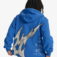 Person wearing a blue hoodie with a large gray flame design on the back, on a white background