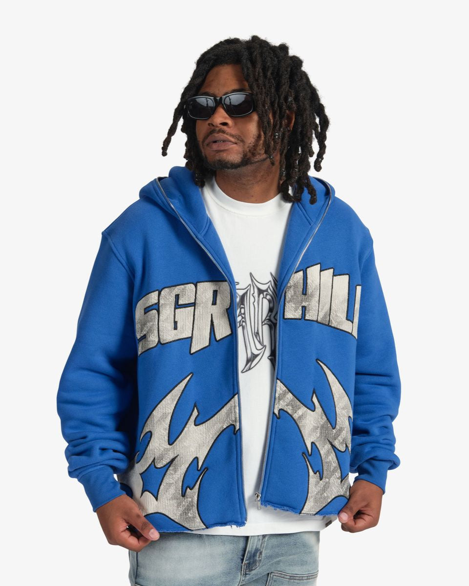 Person wearing a blue hoodie with 'SGR' logo on a white background
