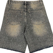Black and white polka dot shorts on a white background