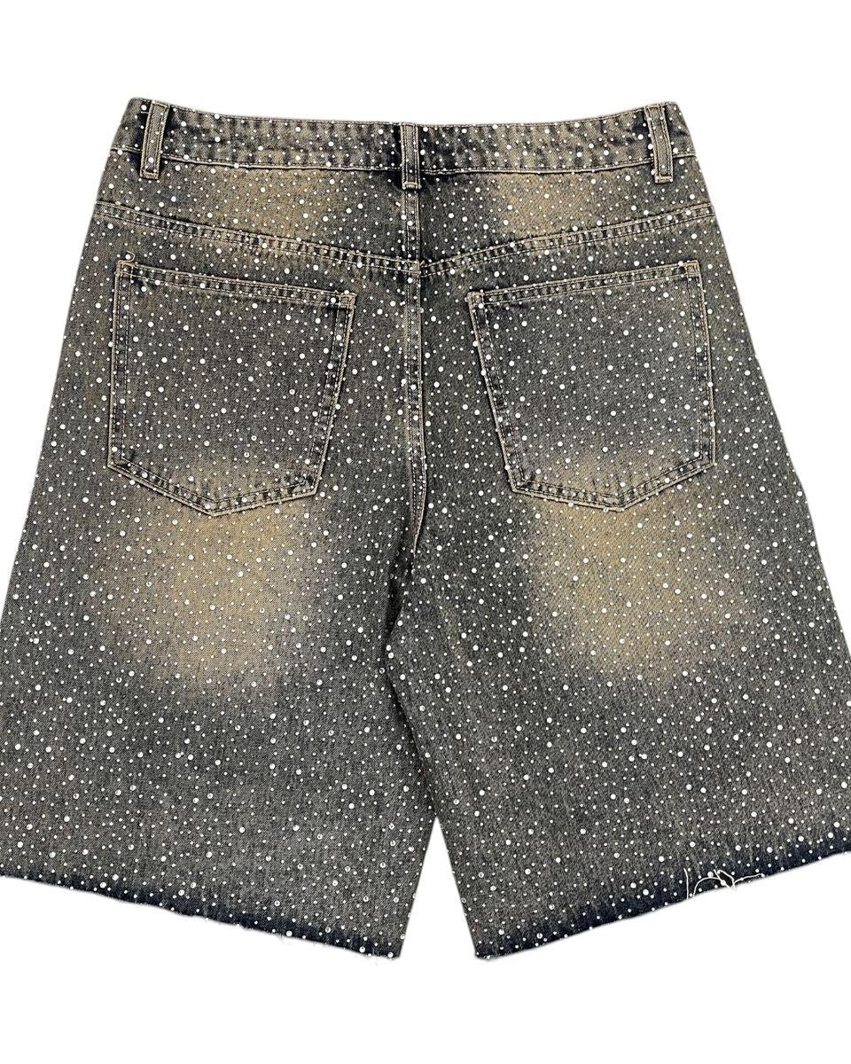 Black and white polka dot shorts on a white background