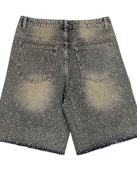 Black and white polka dot shorts on a white background