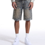 Person wearing a white sweatshirt with text, denim shorts with star patterns, and white sneakers on a white background