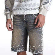 Person wearing a graphic sweatshirt and sequin shorts on a white background