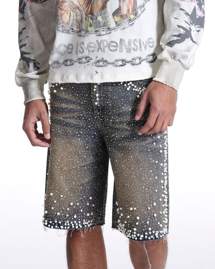 Person wearing a graphic sweatshirt and sequin shorts on a white background