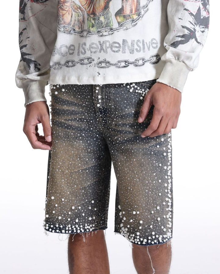 Person wearing a graphic sweatshirt and sequin shorts on a white background