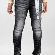 Person wearing black distressed jeans with a visible brand label on a white background