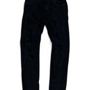 Black slim-fit jeans with distressed details, shown flat against a white background.