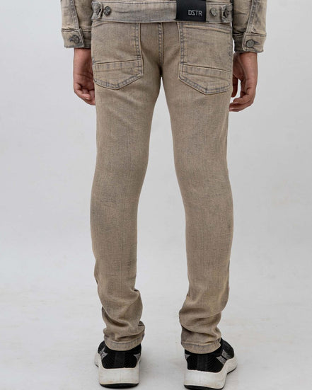 Beige pants worn by a person on a white background
