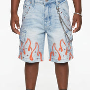 Denim shorts with flame design worn by a person on a white background