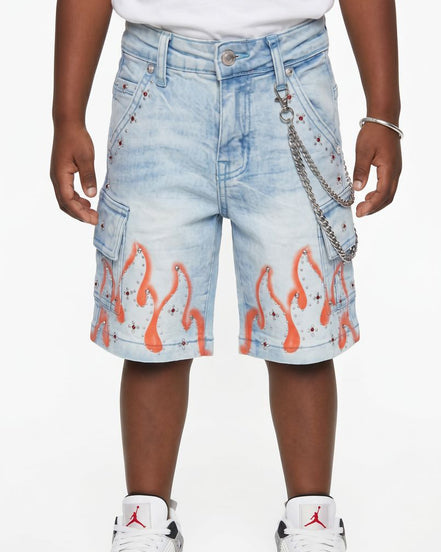Denim shorts with flame design worn by a person on a white background