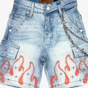Denim shorts with embellishments and orange designs on a white background