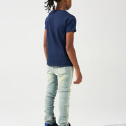 Person wearing a navy blue t-shirt, light blue jeans, and black sneakers on a white background