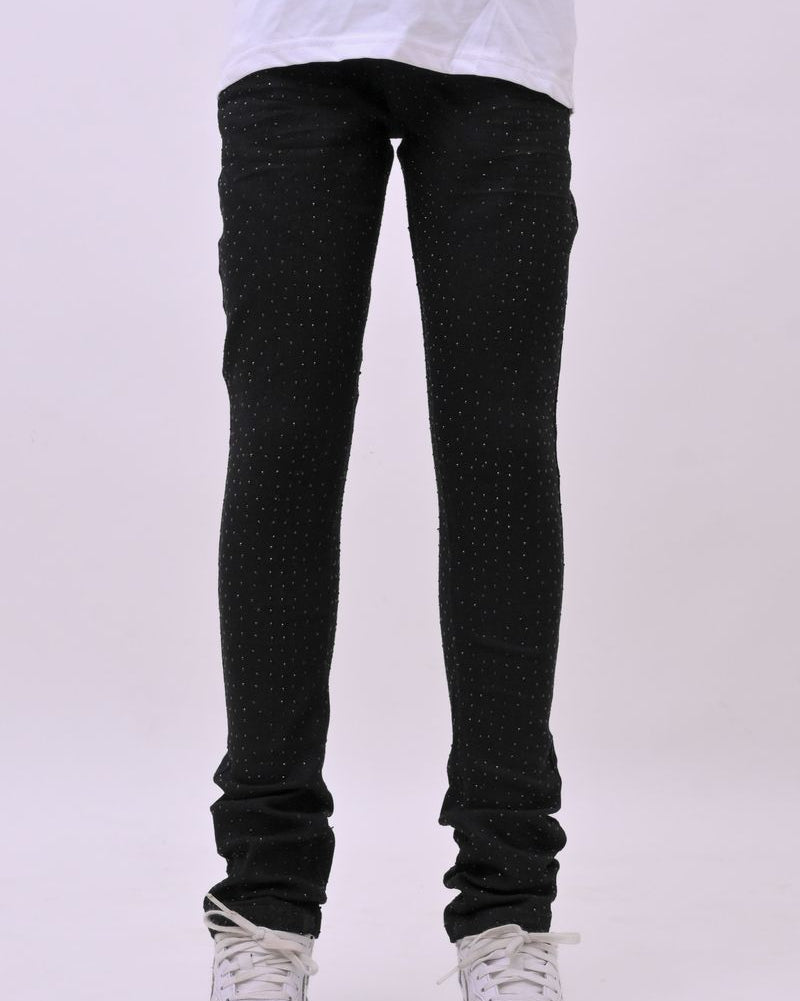 Person wearing black rhinestone pants and white sneakers on a white background