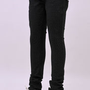Person wearing black pants and white sneakers on a white background