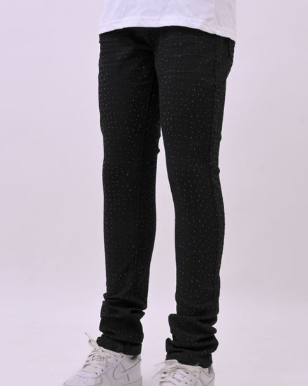 Person wearing black pants and white sneakers on a white background