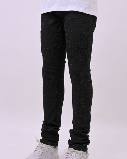 Person wearing black pants and white sneakers on a white background