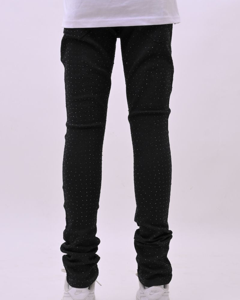 Person wearing black jeans and white sneakers on a white background