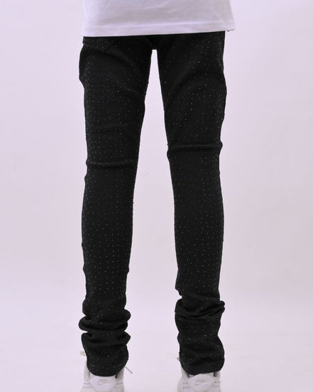 Person wearing black jeans and white sneakers on a white background