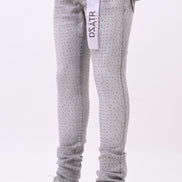 Gray patterned jeans with a brand tag on a white background
