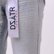 Gray pants with rhinestone details and a visible brand label on a white background