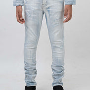 Light blue distressed jeans worn by a person on a white background