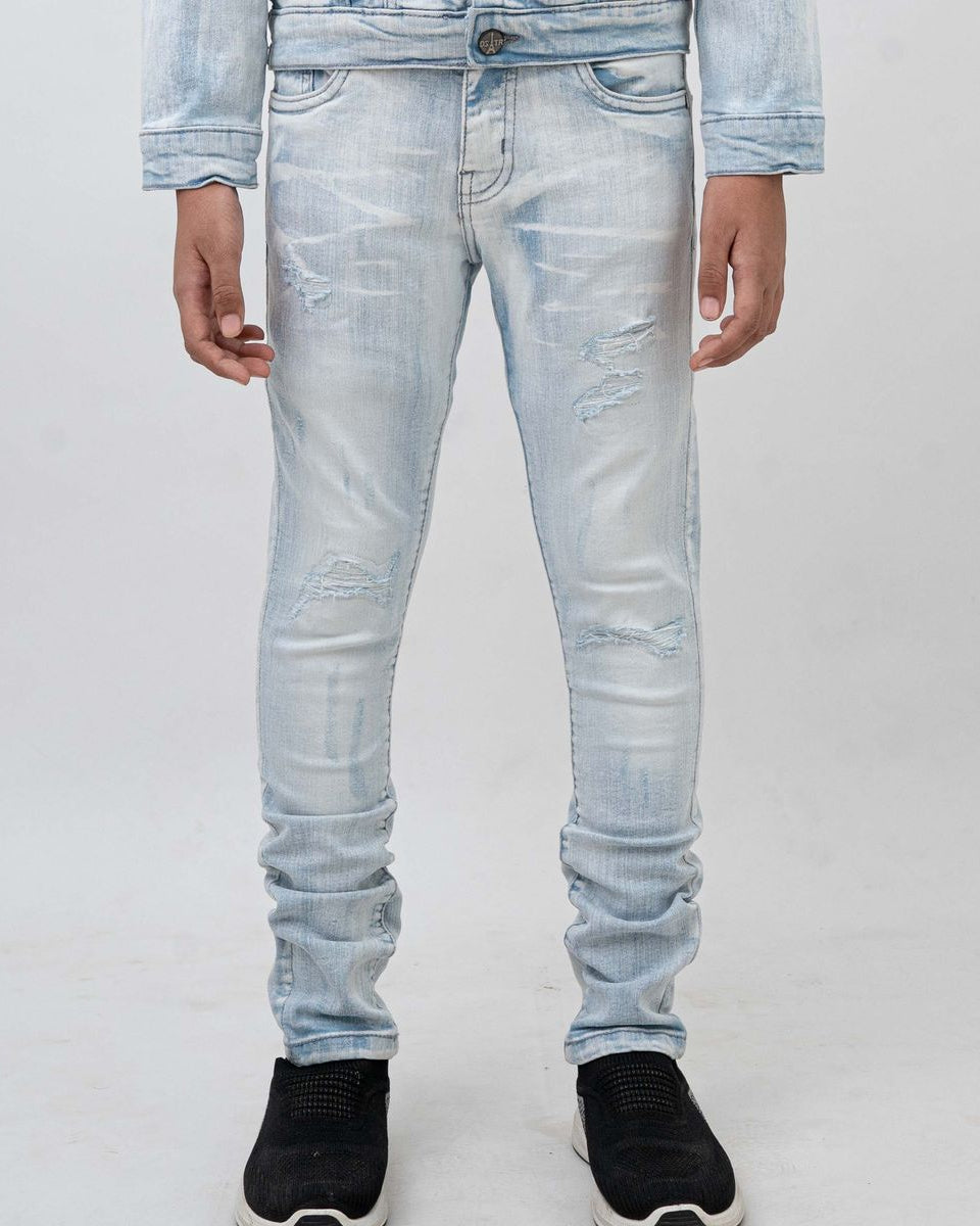 Light blue distressed jeans worn by a person on a white background