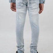 Light blue jeans worn by a person on a white background