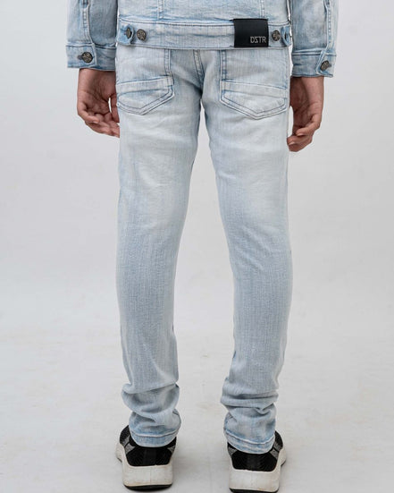 Light blue jeans worn by a person on a white background