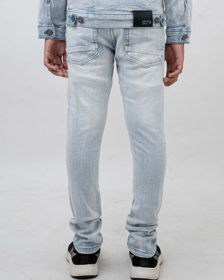 Light blue jeans worn by a person on a white background
