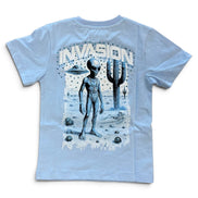 A light blue short-sleeve t-shirt with a large graphic print on the back featuring a silver alien, a cactus, UFOs, and the word 'INVASION' in a distressed stencil font.
