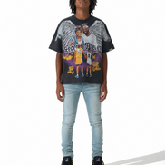 A model wearing a black Los Angeles Lakers graphic t-shirt with a detailed print of Kobe Bryant and Angel, paired with light wash blue jeans and black sneakers, shot against a white studio background.