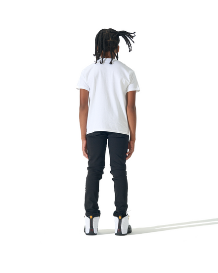 A child model shown from the back wearing a white short-sleeve t-shirt, black pants, and white sneakers, standing against a solid white background.