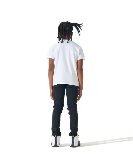 A child model shown from the back wearing a white short-sleeve t-shirt, black pants, and white sneakers, standing against a solid white background.
