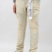 Person wearing light-colored distressed jeans with a brand label on a white background