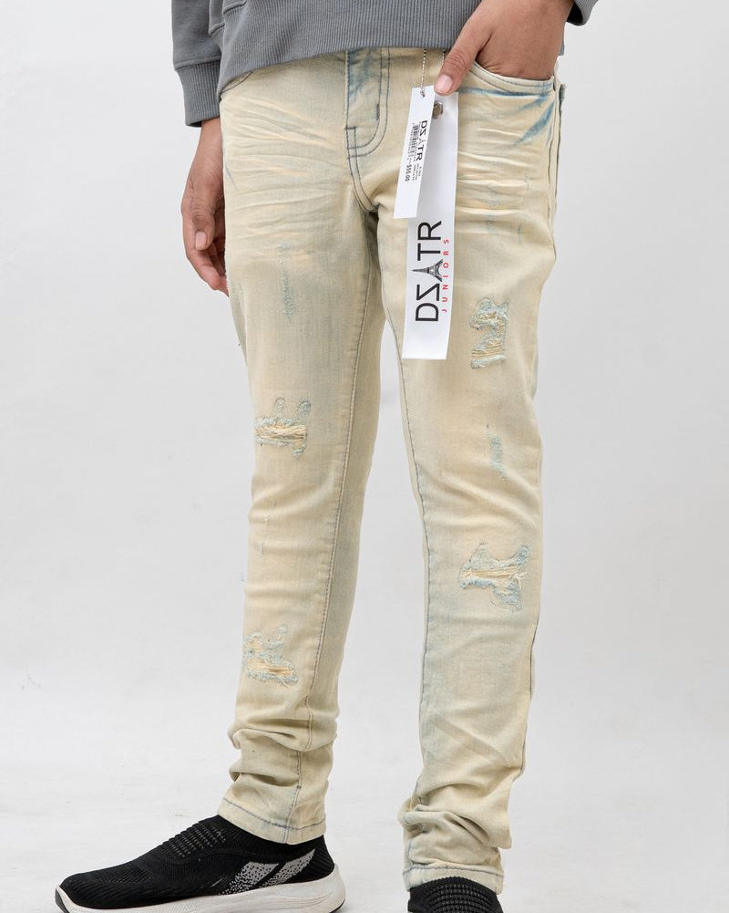 Person wearing light-colored distressed jeans with a brand label on a white background